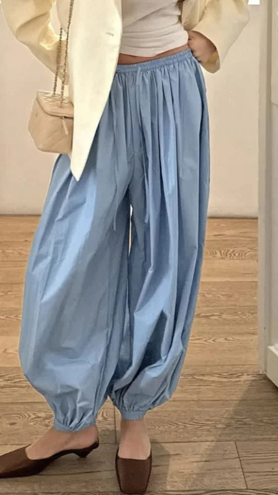 Person wearing light blue pants and a beige jacket 