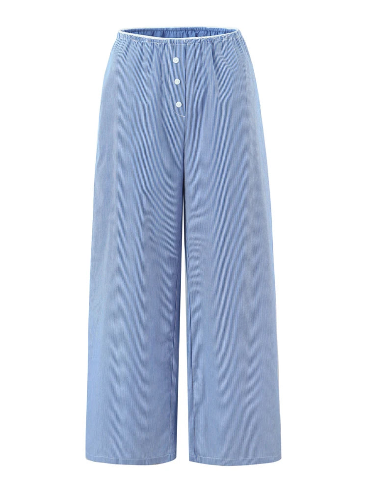 Light blue wide-leg pants with button details on a white background