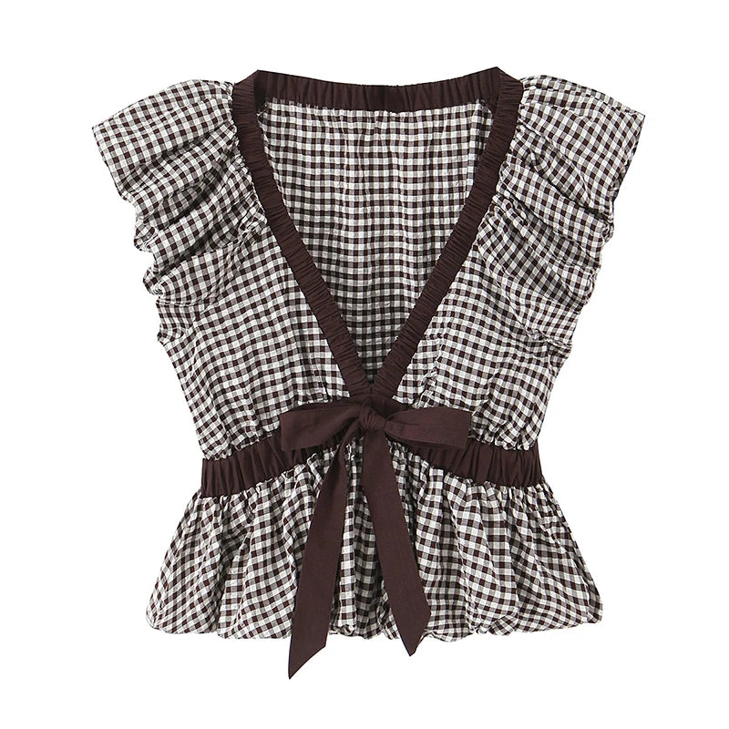 Black and white checkered top with brown straps and trim on a white background