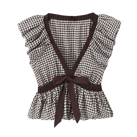 Black and white checkered top with brown straps and trim on a white background