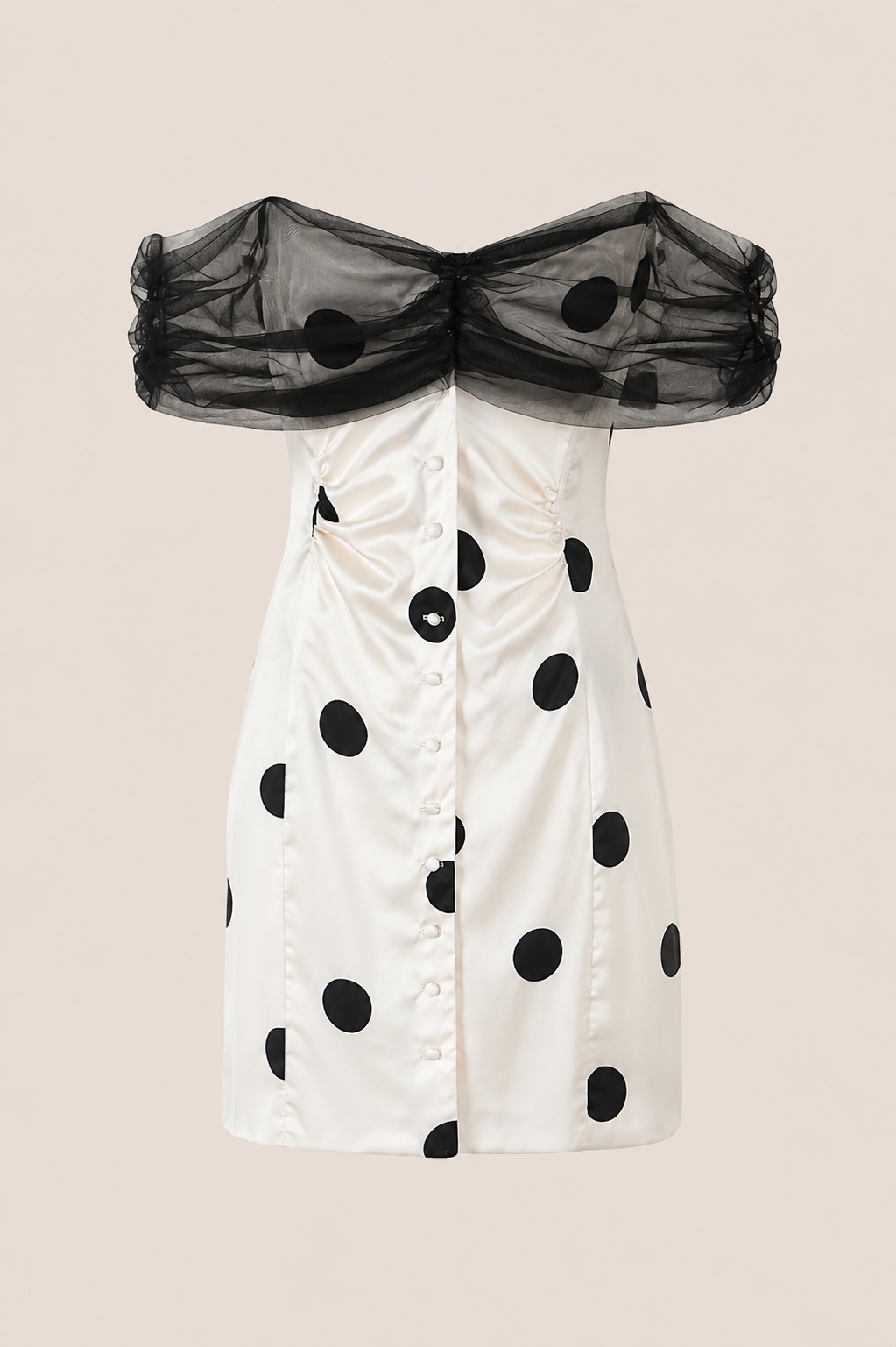 An off-the-shoulder white dress with black polka dots and a sheer black mesh ruffled collar, shown against a solid beige background.